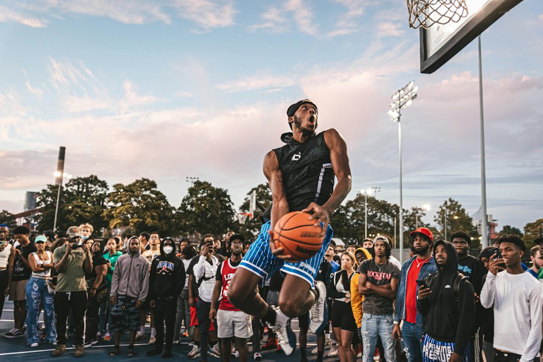 A player dunking in front of a packed, cheering crowd